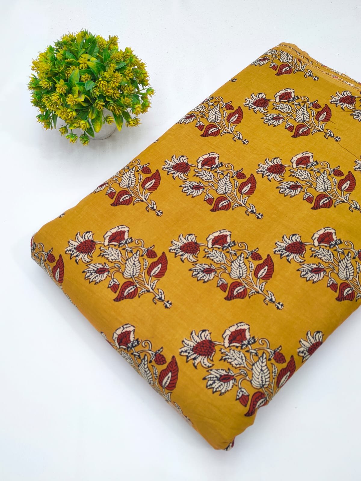 Mustard ethnic motif screen print cotton fabric