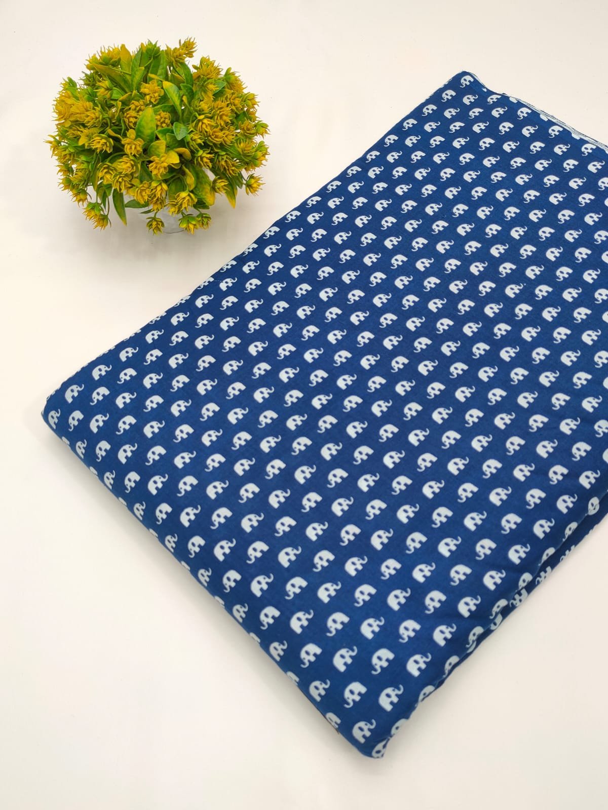Blue cotton fabric with white ethnic motif print
