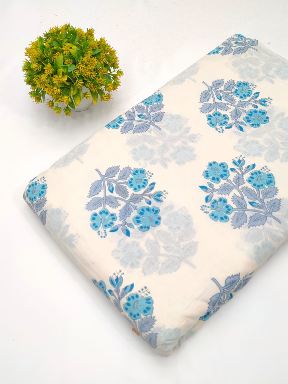 White cotton fabric with blue floral pattern