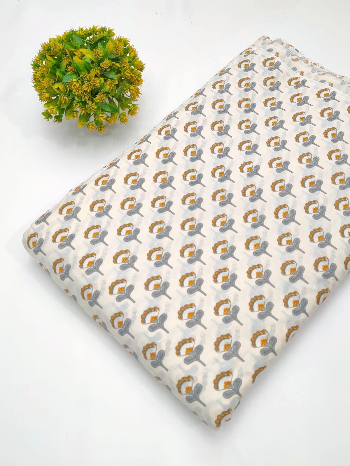 White fabric with grey and brown ethnic motifs