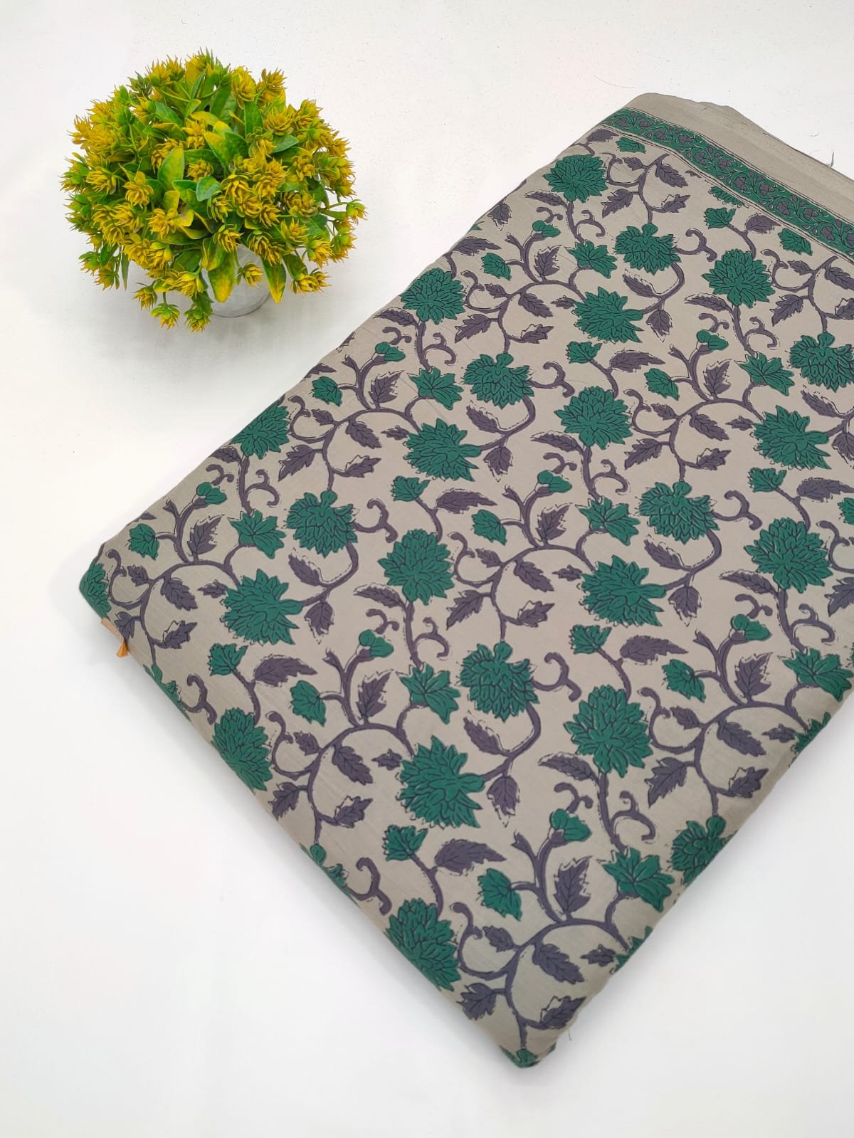 Grey green ethnic motif screen printed cotton fabric