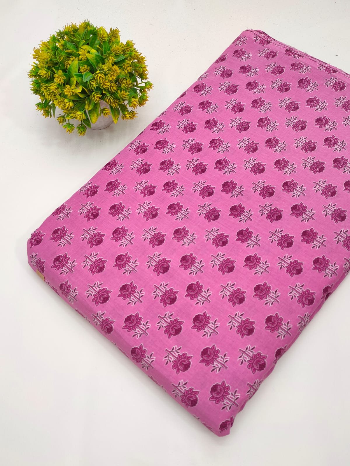 Pink fabric with small floral screen print design