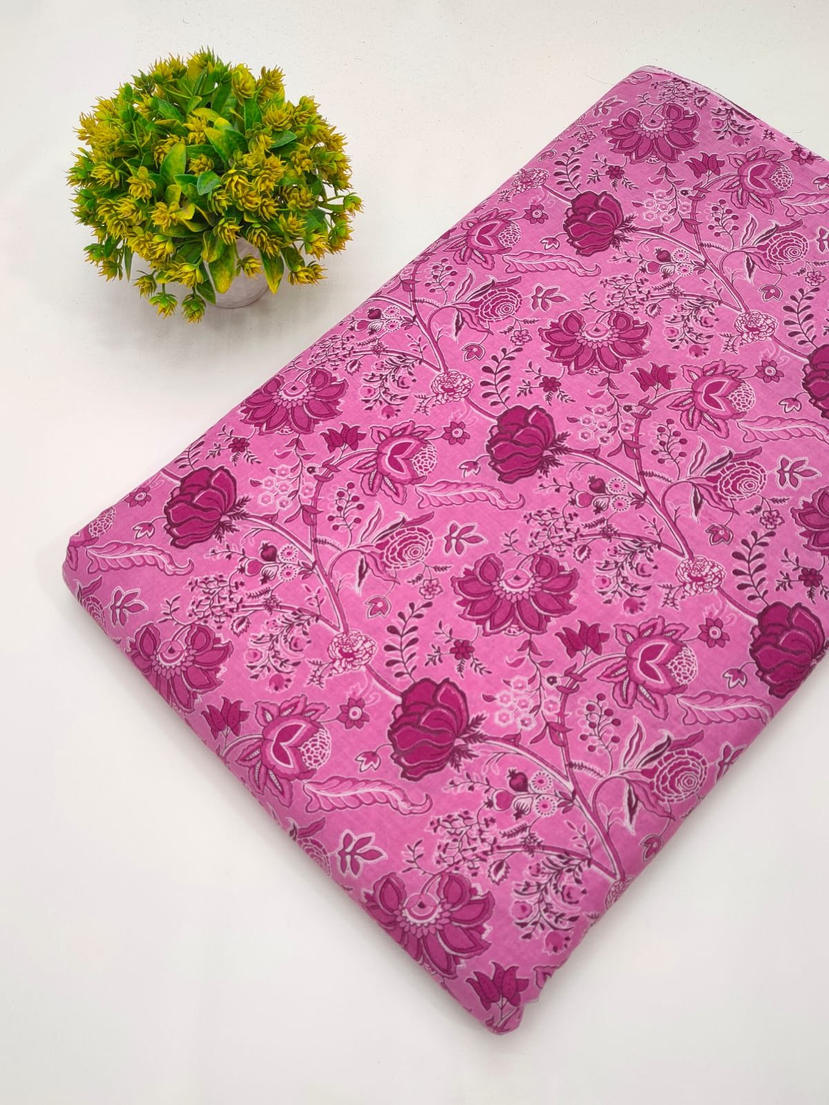 Pink fabric with detailed nature-inspired screen print